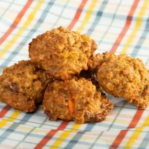 Carrot Cookies stacked on tablecloth