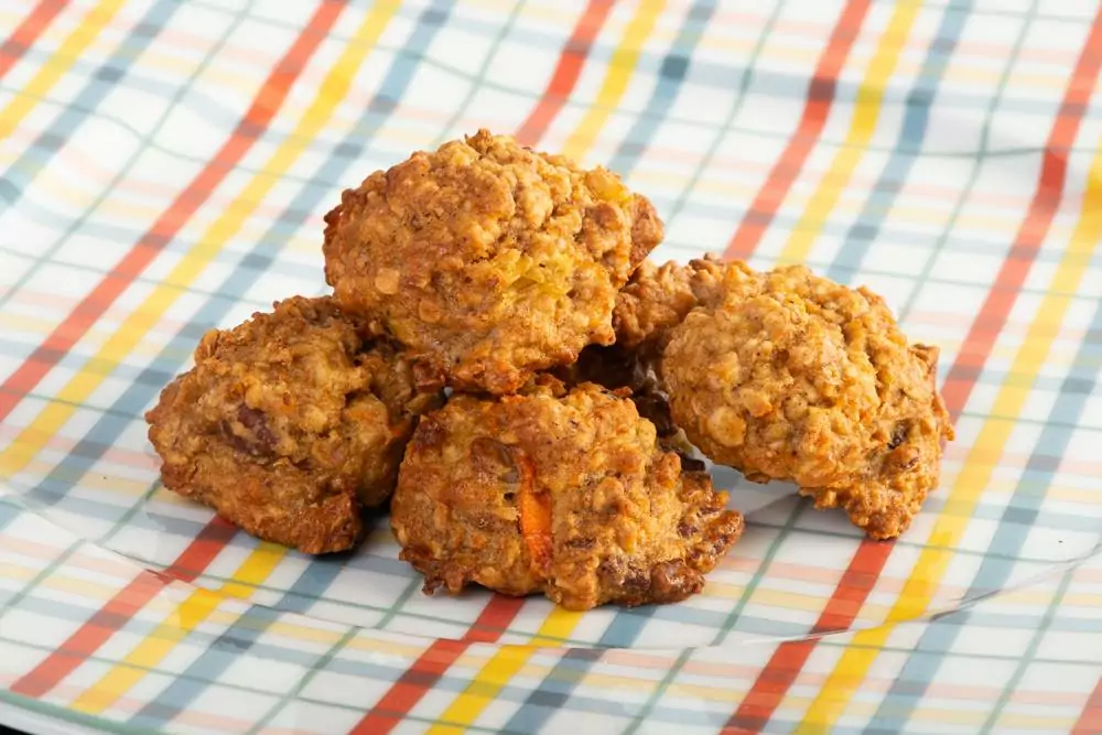 Carrot Cookies stacked on tablecloth