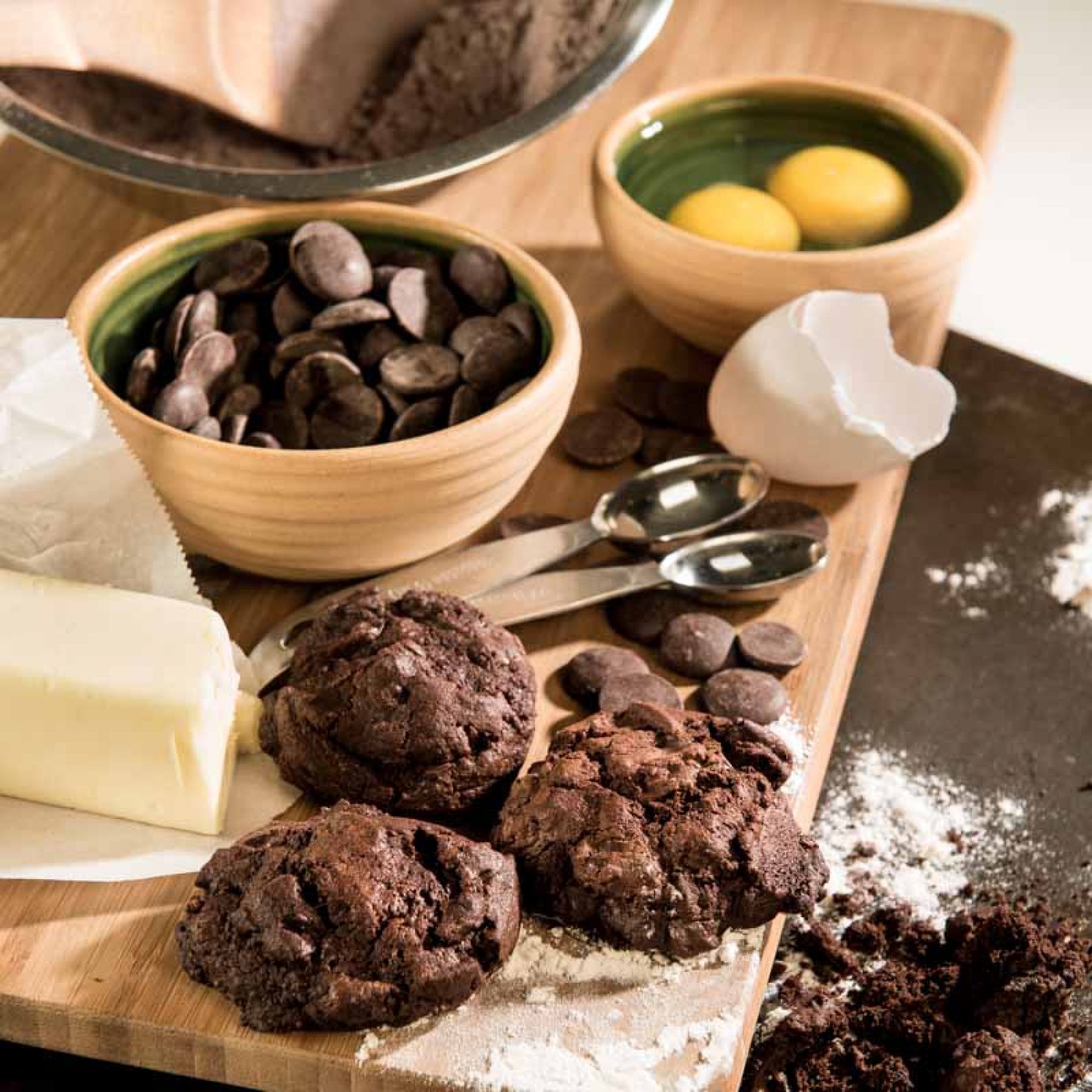 Chocolate Brownie Cookies placed on cutting board with chocolate chips