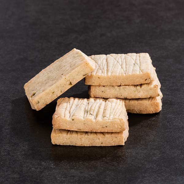 Rosemary shortbread with vodka and cardamom placed on table with fresh rosemary.