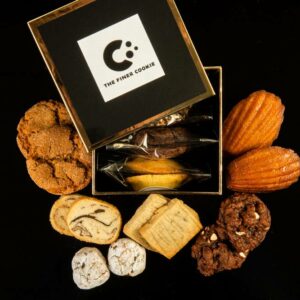 Individually Wrapped Cookies in Signature Gift Box placed on a table with cookies placed around the box.