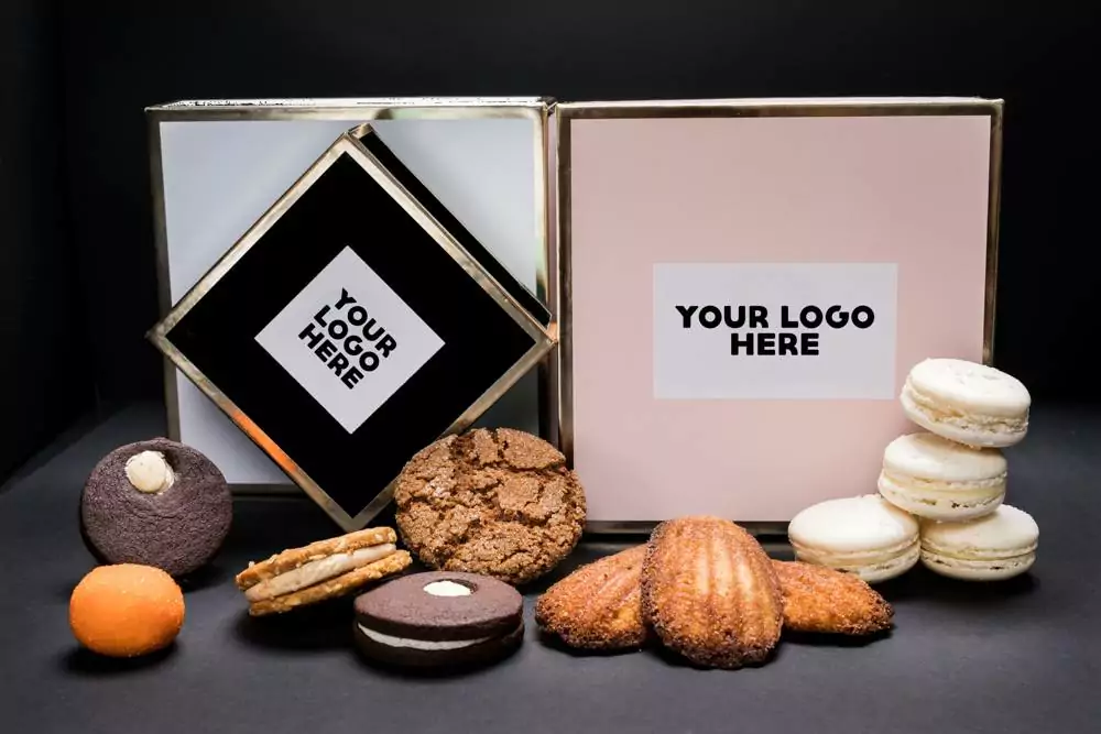 Customized Gift Boxes placed on table with multiple cookies placed around boxes.