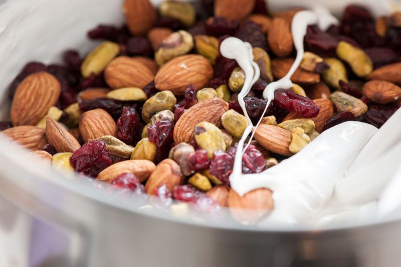 Adding the fruit and nut mixture to the warm meringue.