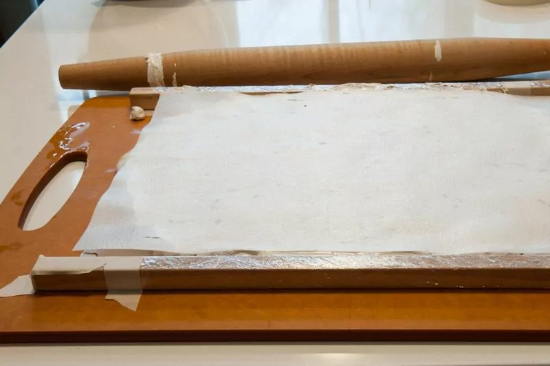 Rolling the nougat between wafer paper inside the form.