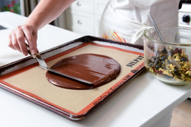 Spreading the melted chocolate with an offset spatula.