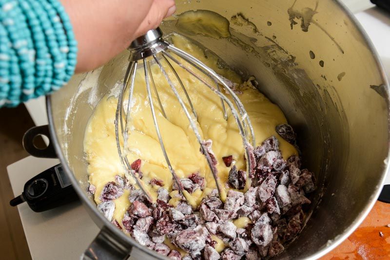 Folding the cherries into the cake batter.