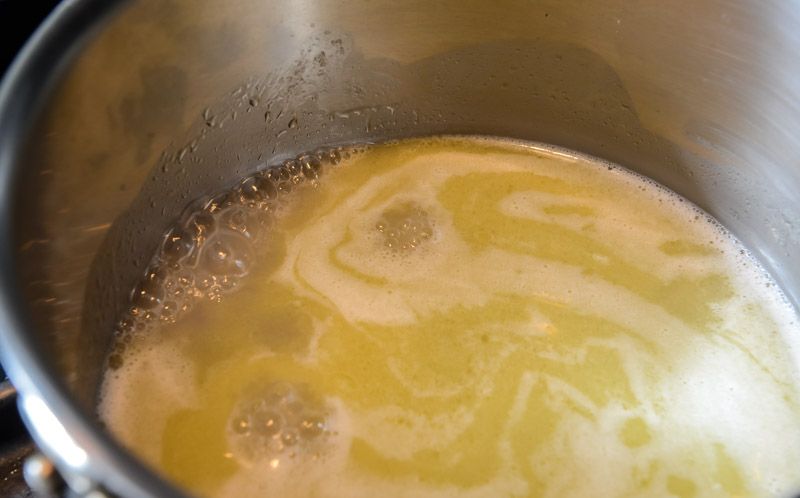 Bringing the butter water and salt to a simmer.