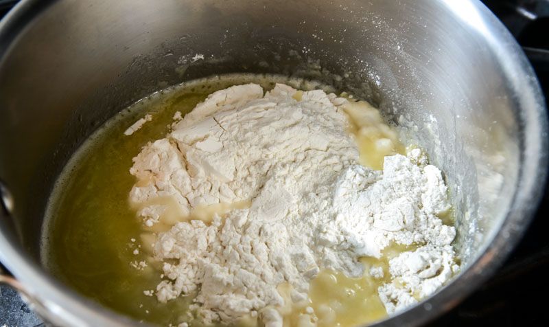 Adding the bread flour to the melted butter.