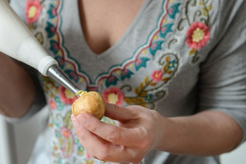 Filling the choux with pastry cream.