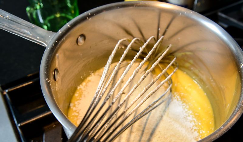 Sifting the cornstarch and flour into the pastry cream.