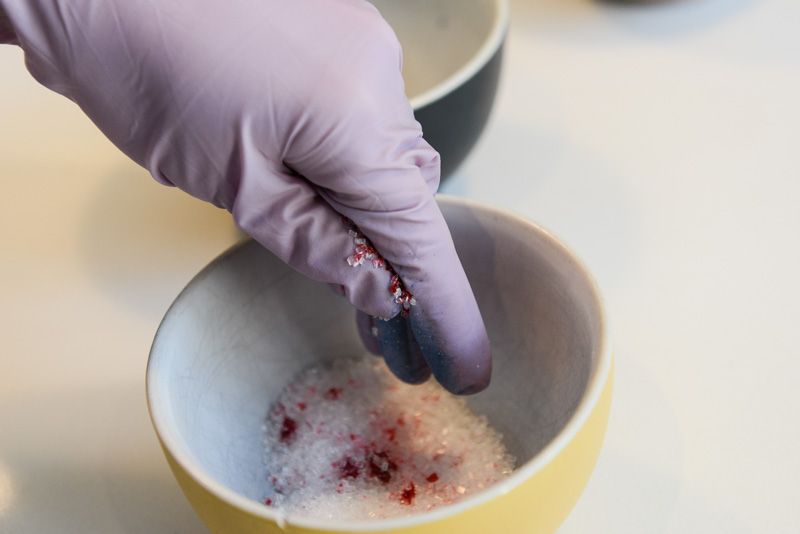 Colouring white sugar with food colouring.