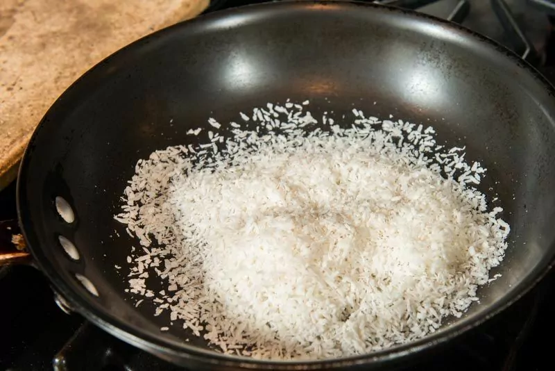 Toast the coconut in a hot skillet.