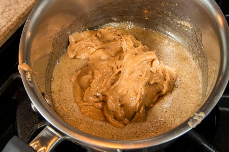 Add the peanut butter to the simmering honey and brown sugar.