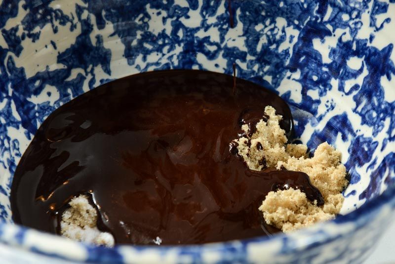 Pour melted chocolate and butter over the two sugars.