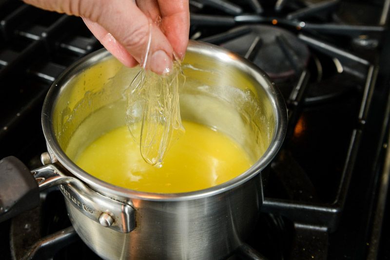 Add softened sheets of gelatine to the cooked lemon curd.