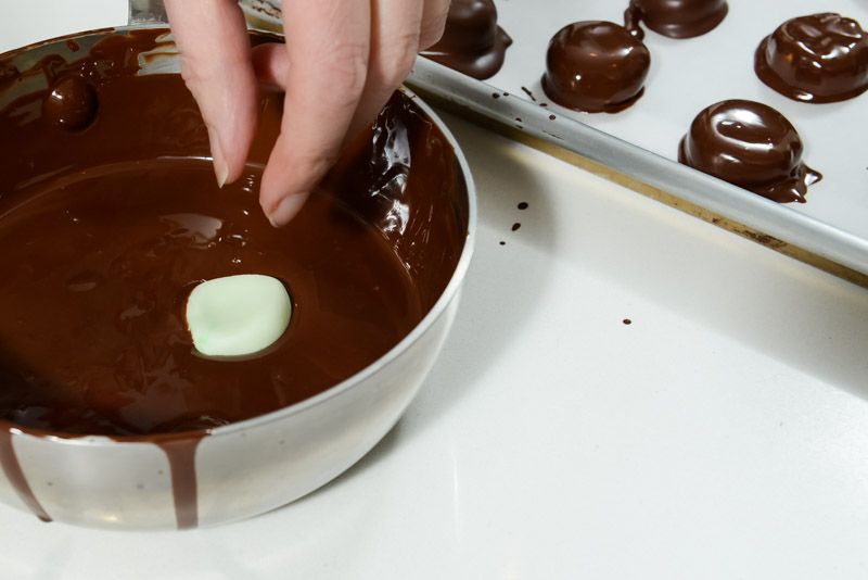 Drop a peppermint patty in the melted chocolate.
