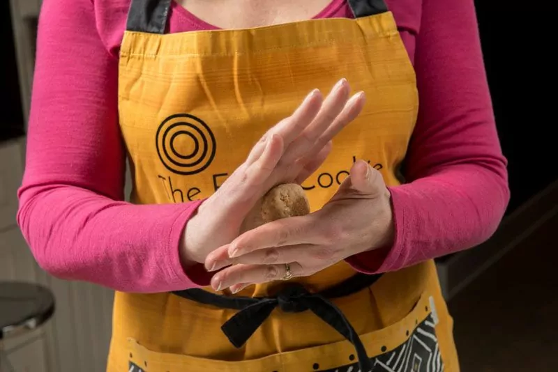 Rolling the peanut cookie dough.