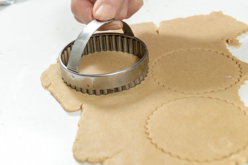 Cutting the cookies with 3 inch fluted cutters.