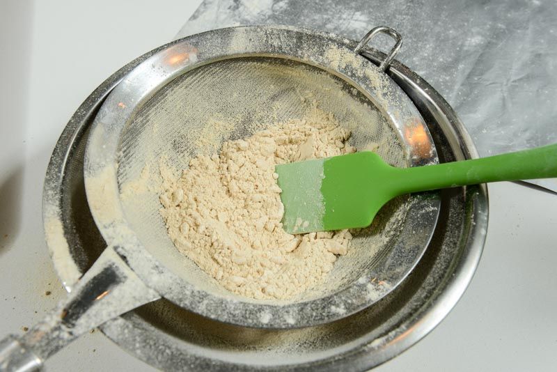 Sift the toasted flour to break up the clumps, and lighten the batter.