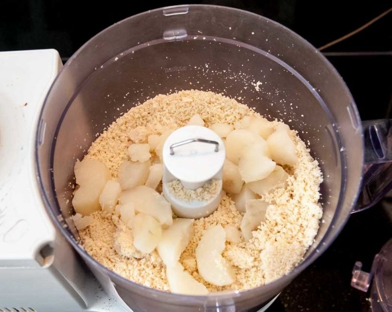 Adding potatoes to the almonds.