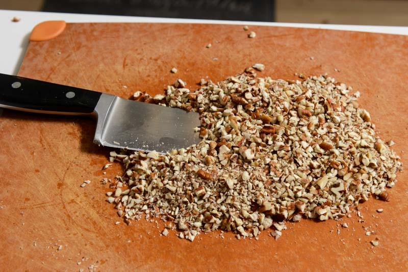 Chopping pecans for the butterscotch cookies.