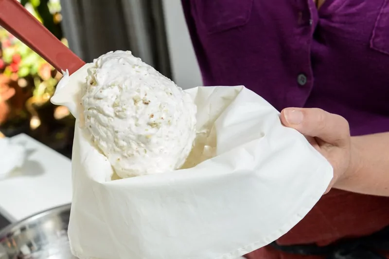 Spooning the cookie batter into the large pastry bag.