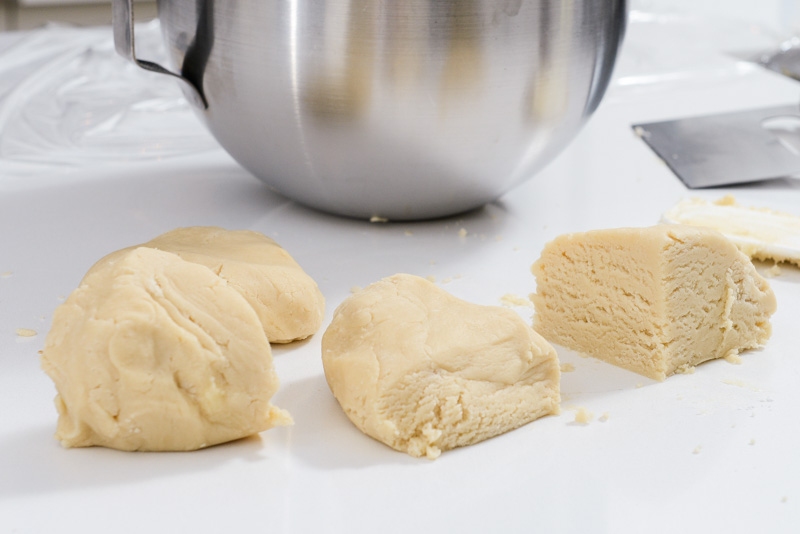 Fresh cookie dough cut in quarters.