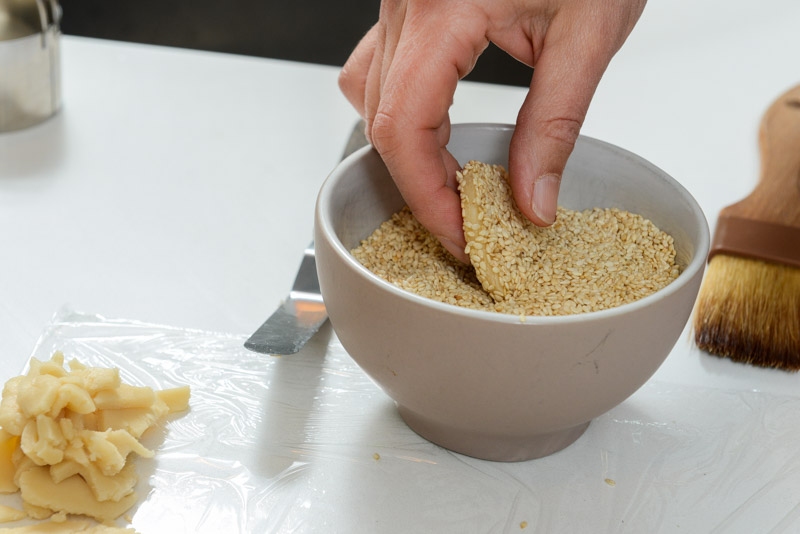 Honey cookies submerged in sesame seeds.