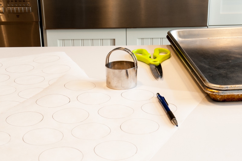 Preparing the parchment before mixing the macaron batter.