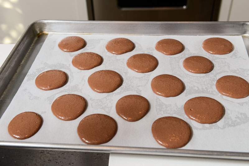 Macaron batter piped and resting before baking.