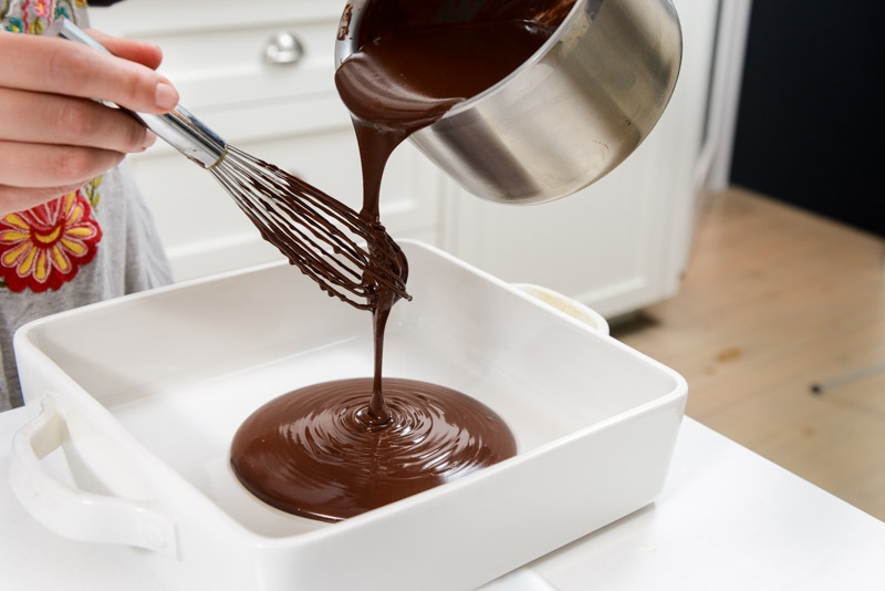 Pouring the ganache into a wide dish helps to cool the chocolate faster.