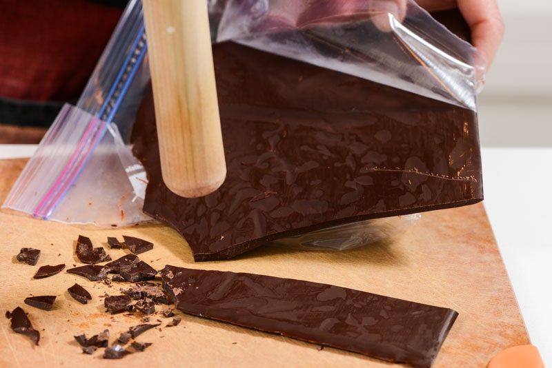 Breaking the salty chocolate garnish for the center of the macaron.