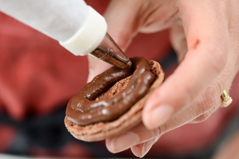 I start at the outside edge of the macaron shell.