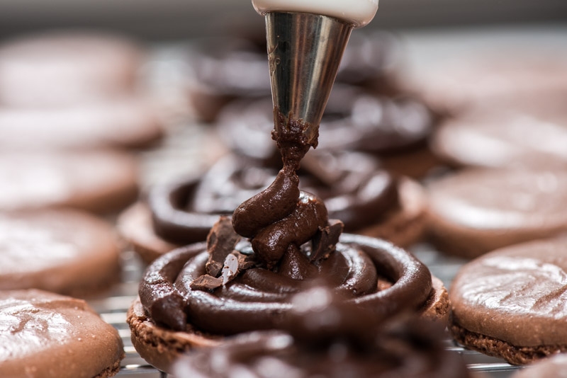 Dabbing the hard chocolate pieces with more ganache.