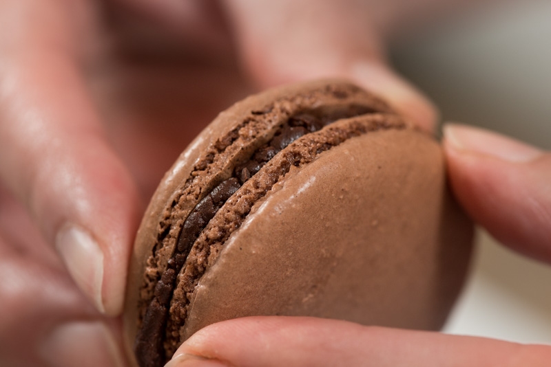 Completing the chocolate macaron.