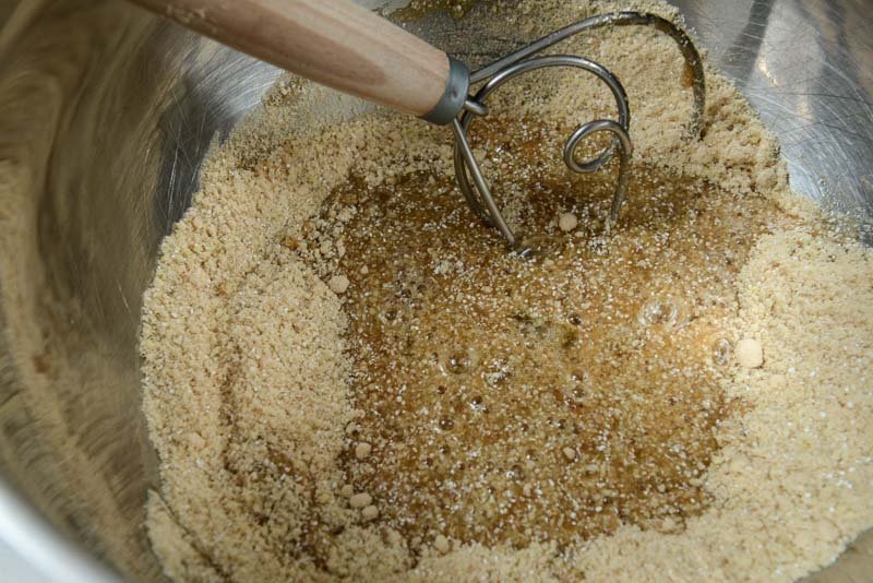 Adding the egg whites into the maple sugar and buckwheat flour.