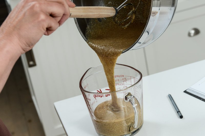 Pouring the batter into a glass cup to refrigerate.