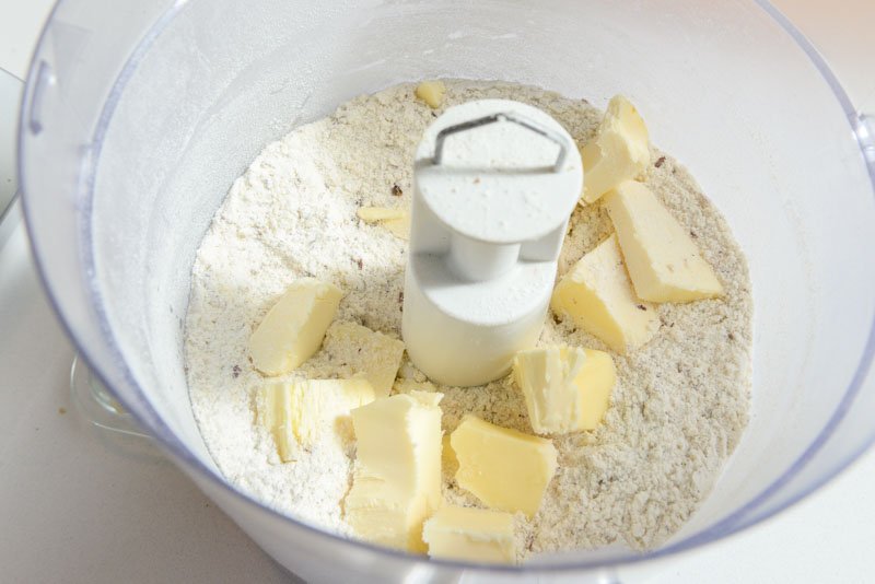 Adding the cold butter into nut/flour mixture.