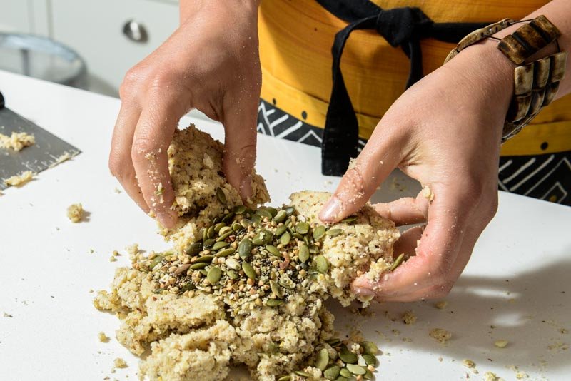 Folding the remaining seeds into the cookie dough.