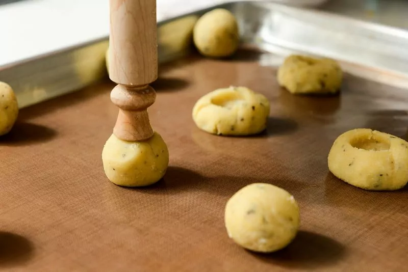 Making the depressions in the rolled cookies.