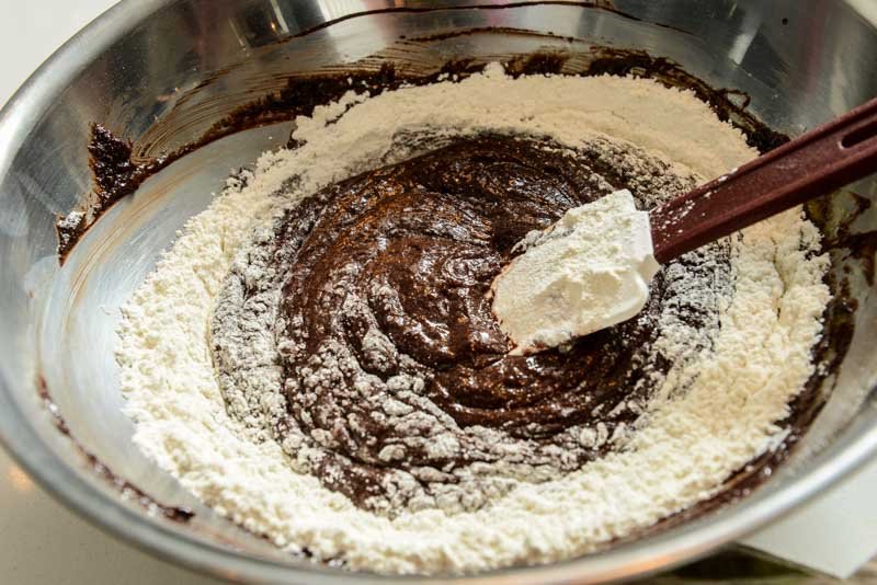 Adding the flour to the chocolate mixture.
