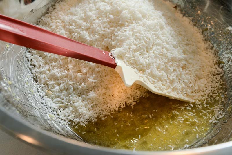 Adding the coconut to the egg white mixture.