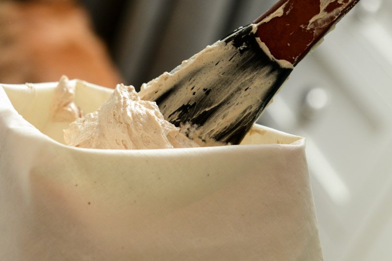 Adding the peanut butter cream to the pastry bag.