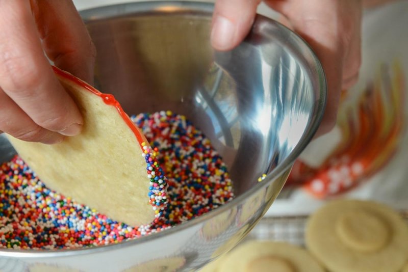 Dip the edges of the cookie in festive sprinkles.
