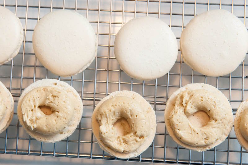 Espresso buttercream piped onto the macaron cookie.