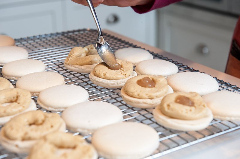 Filling the macaron with pear jelly.