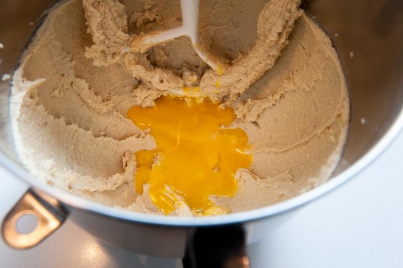 Adding the egg yolks to the creamed butter and sugar