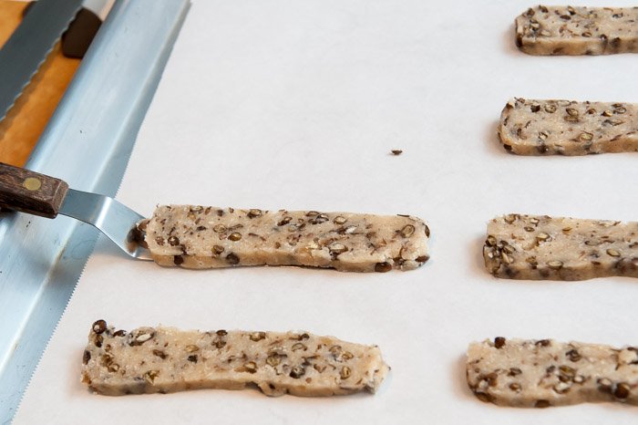 Placing the cookies on the tray with a offset spatula.