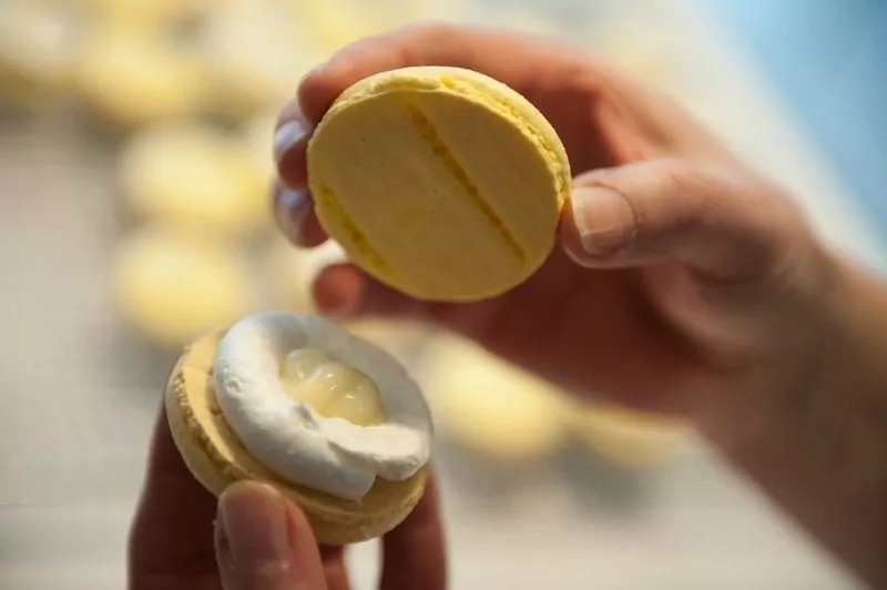 Sandwiching the lemon macarons.