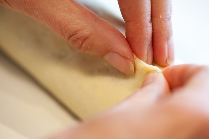 Pinching the seams of the brioche dough.